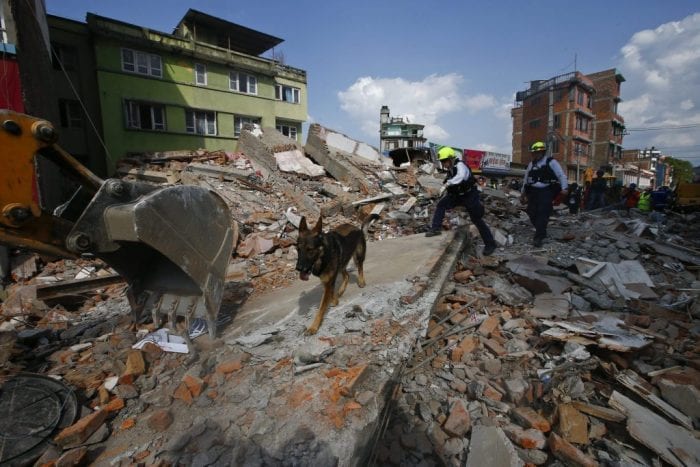 epa04744465 US rescue workers search for survivors at the site after a house collapsed during a strong earthquake, in Kathmandu, Nepal, 12 May 2015. More than 20 people were killed 12 May by the latest earthquake to hit the Himalayas, just 17 days after large parts of Nepal were levelled and more than 8,000 had died. A 7.4-magnitude quake caused the collapse of several buildings in Kathmandu and other areas of Nepal, officials said.  EPA/NARENDRA SHRESTHA